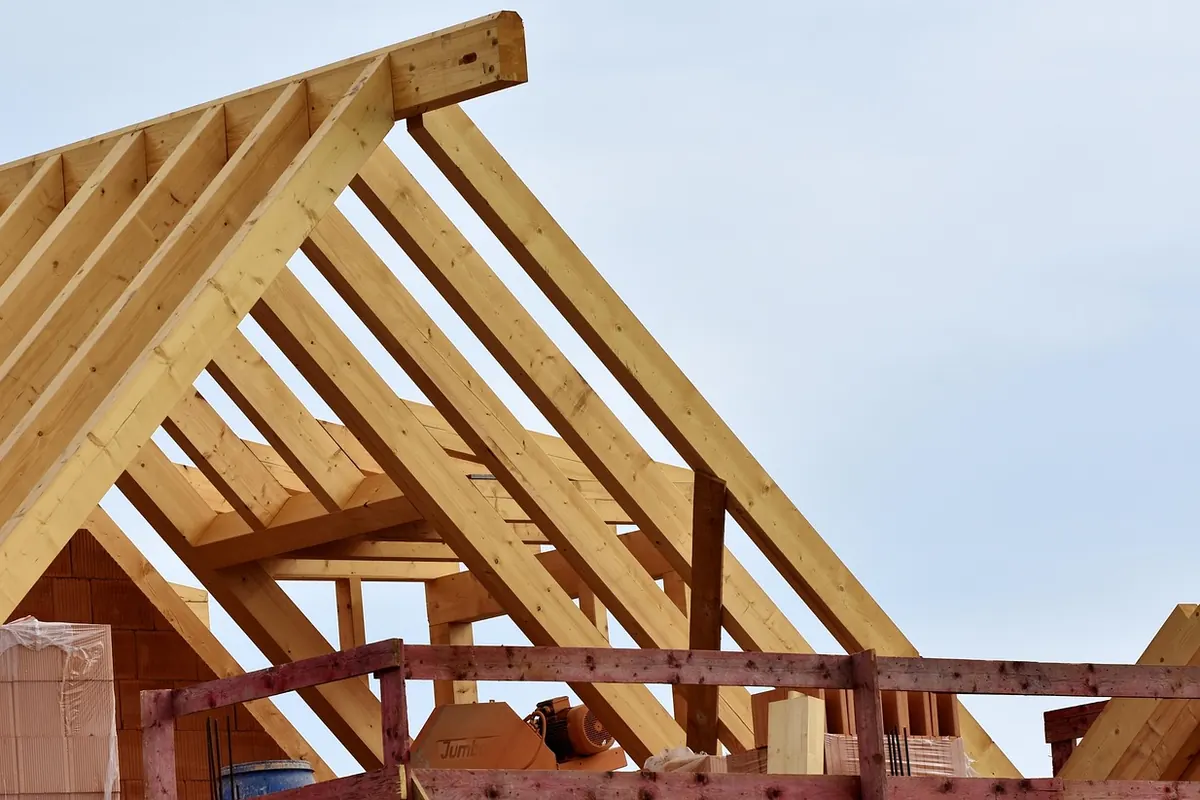 Charpente en bois d'une maison neuve en construction sous un ciel clair